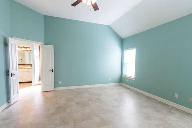 unfurnished bedroom with connected bathroom, ceiling fan, and lofted ceiling