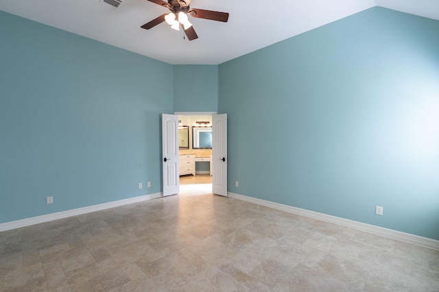 empty room with ceiling fan and lofted ceiling