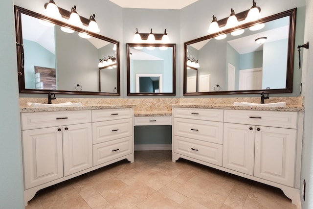 bathroom featuring vanity and vaulted ceiling