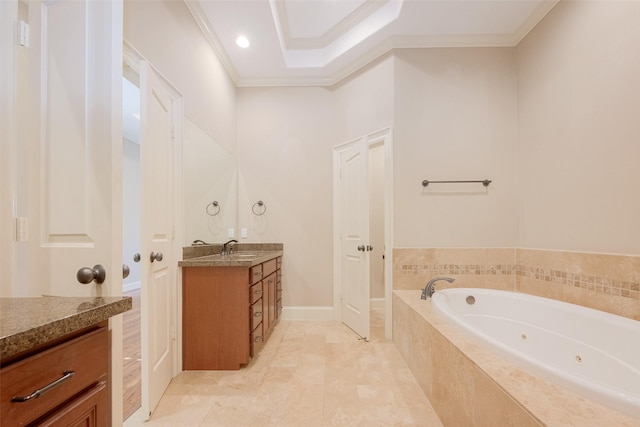 bathroom with vanity, crown molding, tiled tub, and a tray ceiling