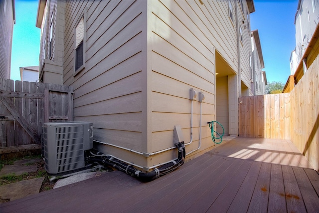 view of property exterior featuring a wooden deck and cooling unit