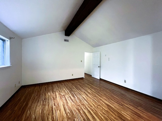 bonus room with dark hardwood / wood-style floors and lofted ceiling with beams