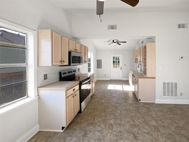 kitchen with sink, light brown cabinets, stainless steel appliances, backsplash, and electric panel