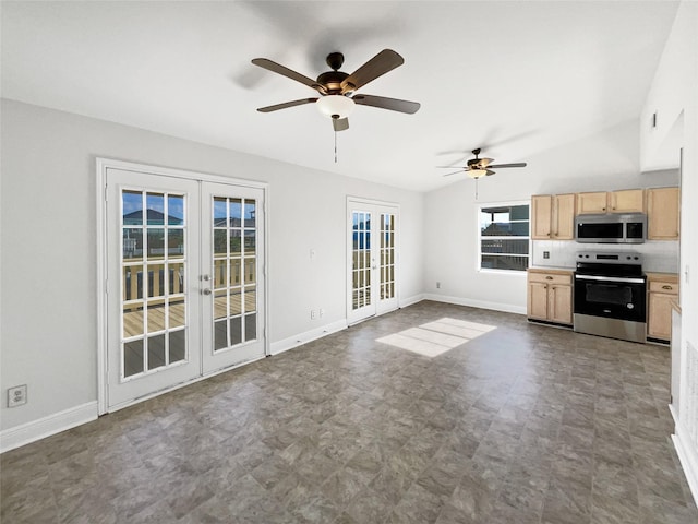 unfurnished living room featuring ceiling fan, french doors, and vaulted ceiling