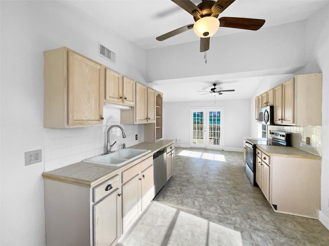 kitchen with ceiling fan, sink, stainless steel appliances, decorative backsplash, and light brown cabinetry