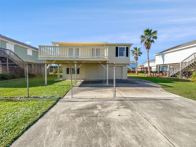 view of front facade with a carport, a garage, a wooden deck, and a front lawn