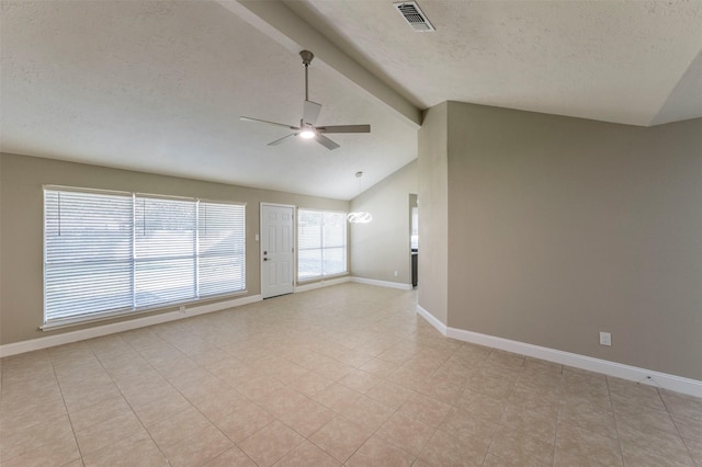 empty room featuring ceiling fan, light tile patterned floors, lofted ceiling with beams, and a textured ceiling