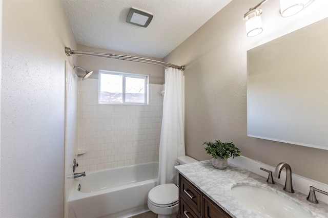 full bathroom featuring shower / bath combo, toilet, a textured ceiling, and vanity