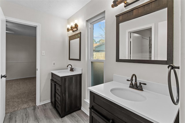 bathroom with hardwood / wood-style floors, vanity, and a textured ceiling