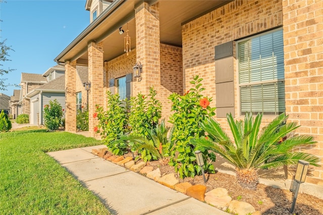 doorway to property with a lawn