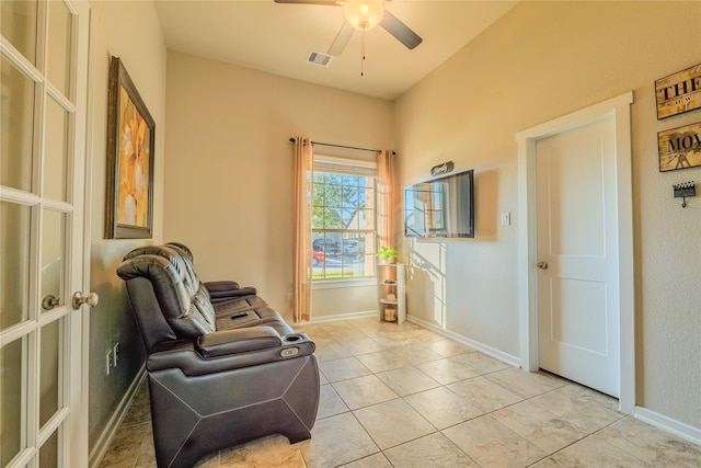 sitting room featuring ceiling fan and light tile patterned floors