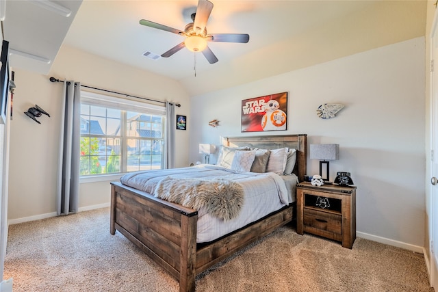 bedroom featuring ceiling fan, light colored carpet, and vaulted ceiling