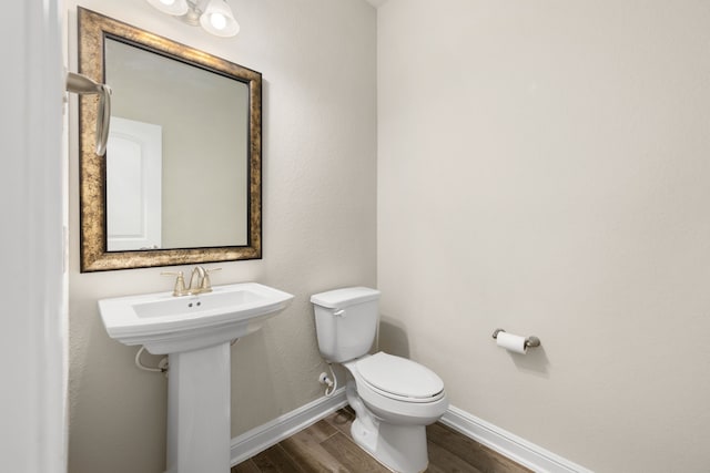 bathroom featuring hardwood / wood-style floors, toilet, and sink