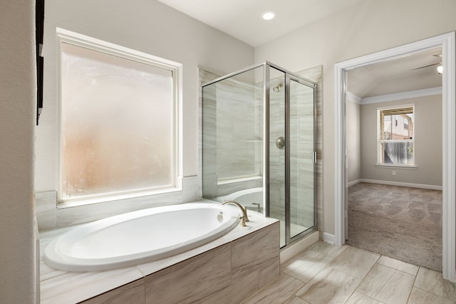 bathroom with crown molding and shower with separate bathtub