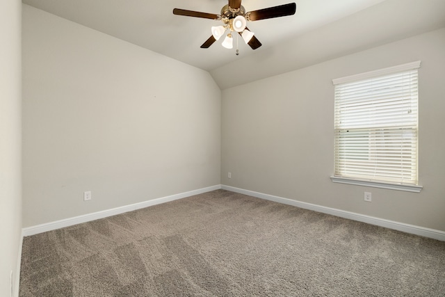 carpeted empty room featuring ceiling fan and lofted ceiling