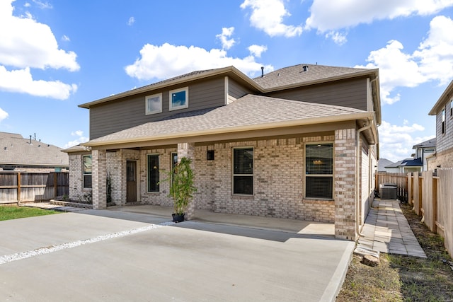 rear view of property featuring central air condition unit and a patio area