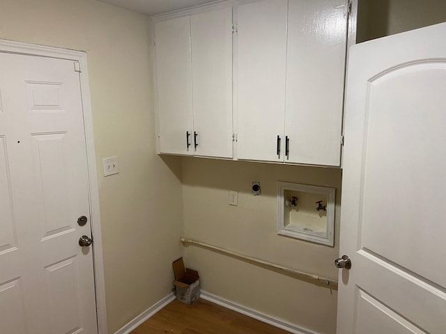 clothes washing area featuring washer hookup, cabinets, dark hardwood / wood-style floors, and hookup for an electric dryer