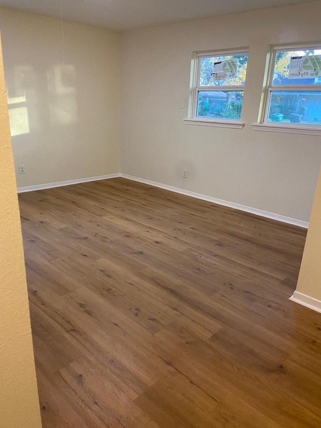 spare room with dark hardwood / wood-style flooring