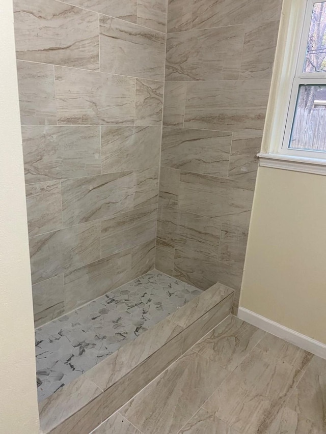 bathroom with a tile shower