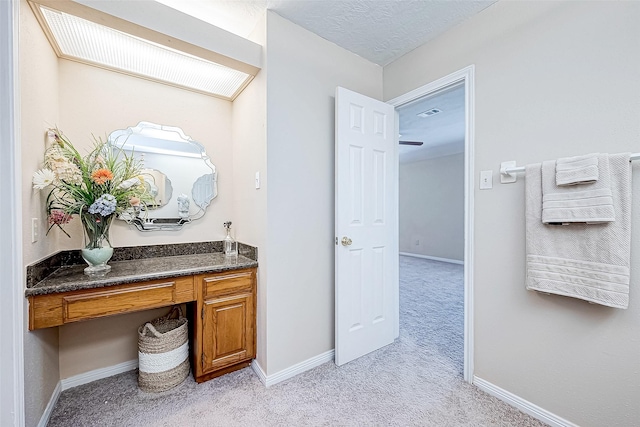 bathroom with vanity and a textured ceiling