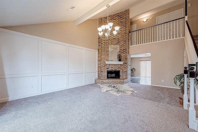 unfurnished living room featuring carpet flooring, a brick fireplace, high vaulted ceiling, an inviting chandelier, and beamed ceiling