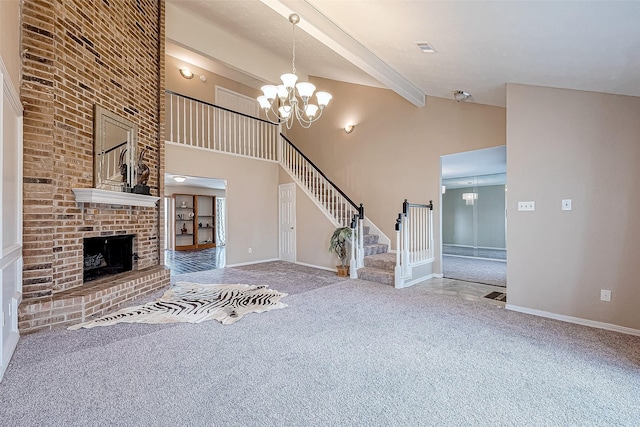 unfurnished living room featuring high vaulted ceiling, a brick fireplace, carpet flooring, beamed ceiling, and a notable chandelier