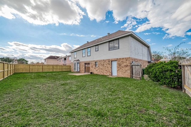 back of property featuring a patio and a lawn