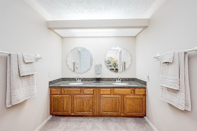 bathroom with vanity and a textured ceiling