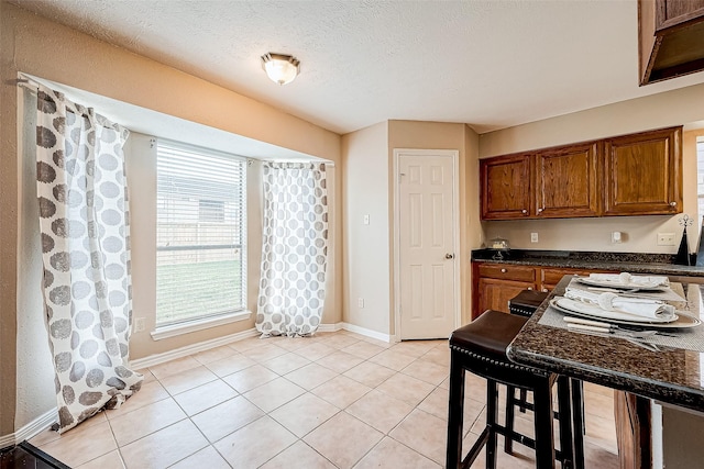 kitchen featuring light tile patterned flooring and a textured ceiling