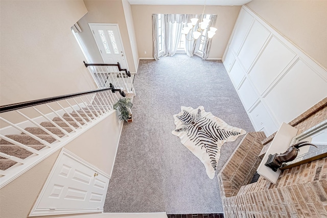 living room with carpet flooring and a notable chandelier