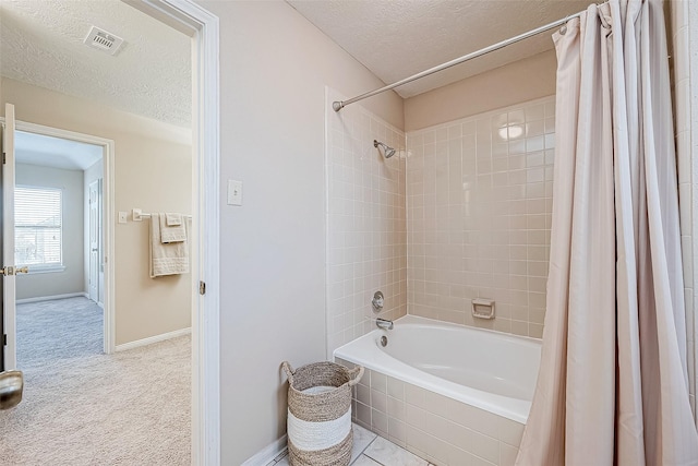 bathroom featuring shower / bathtub combination with curtain and a textured ceiling