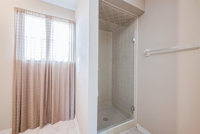 bathroom with tile patterned floors and a shower with door