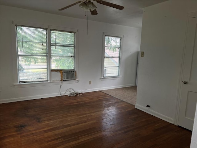 spare room featuring ceiling fan, cooling unit, and dark wood-type flooring