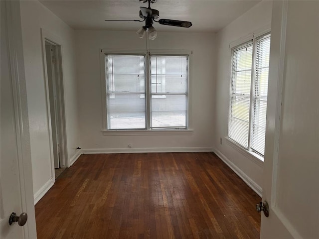 spare room featuring ceiling fan and dark hardwood / wood-style flooring