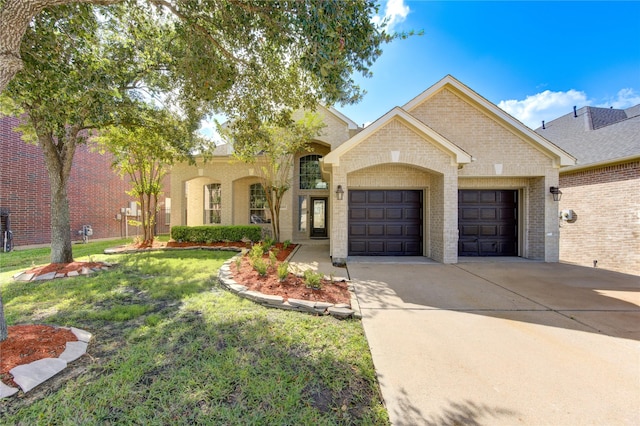 view of front of property featuring a garage and a front lawn