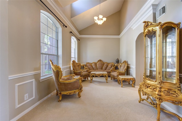 living area with carpet flooring, a notable chandelier, crown molding, and high vaulted ceiling