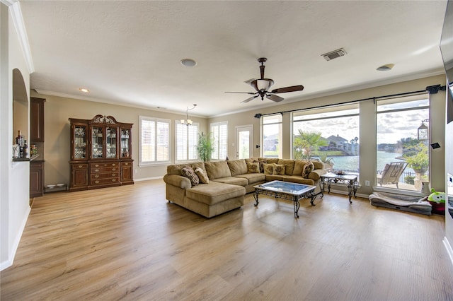 living room with light hardwood / wood-style floors, a water view, and crown molding