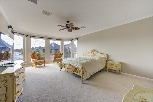 carpeted bedroom with multiple windows, ceiling fan, and ornamental molding