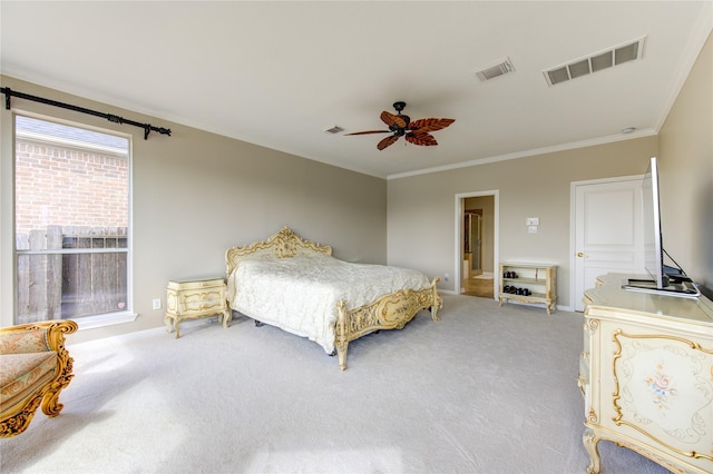 carpeted bedroom with ceiling fan and ornamental molding