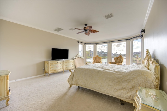 carpeted bedroom featuring ceiling fan and crown molding