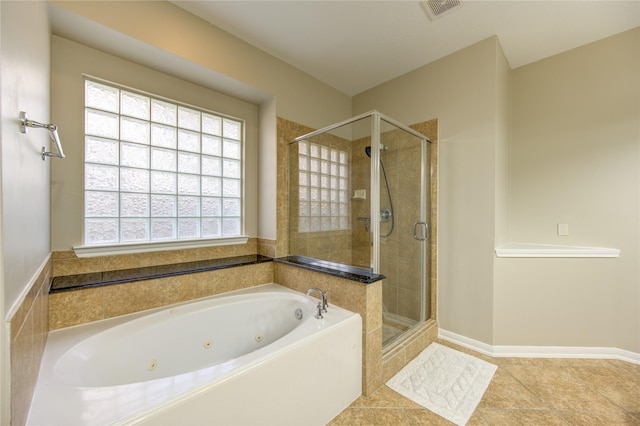 bathroom with tile patterned flooring and shower with separate bathtub