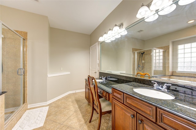 bathroom featuring vanity, tile patterned floors, and a shower with shower door