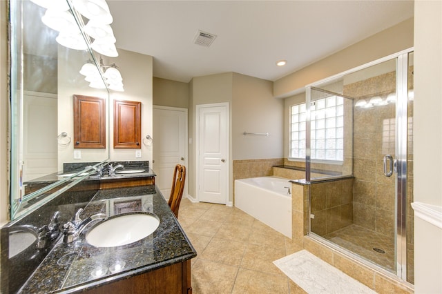 bathroom featuring tile patterned floors, vanity, and plus walk in shower