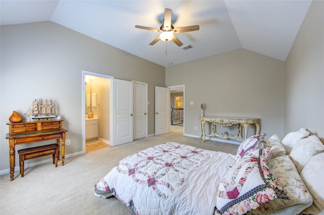 carpeted bedroom with ceiling fan, ensuite bathroom, and vaulted ceiling