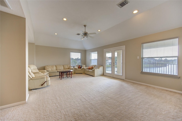 unfurnished living room featuring light carpet, french doors, vaulted ceiling, and ceiling fan