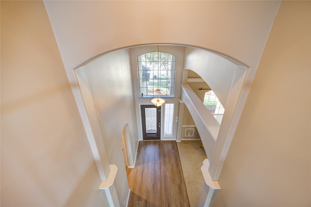 foyer featuring hardwood / wood-style floors and a towering ceiling