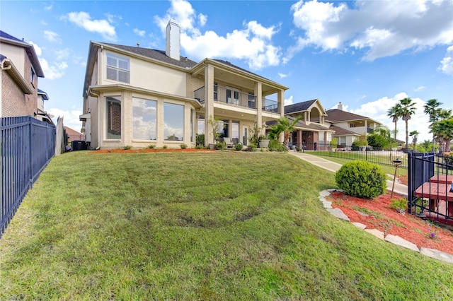 rear view of property with a yard