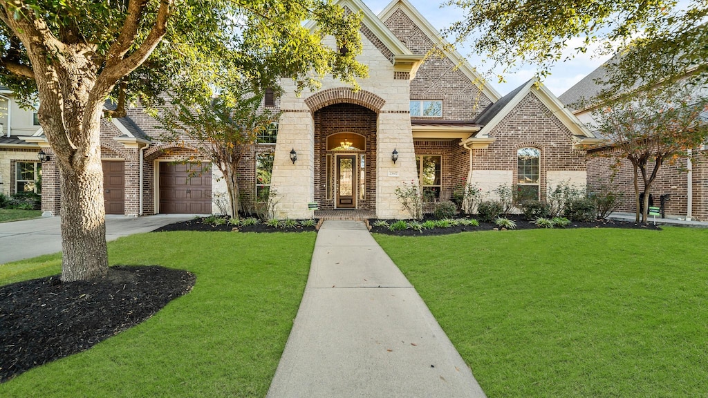 view of front of home with a garage and a front yard