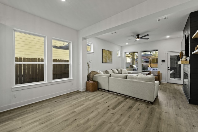 living room featuring hardwood / wood-style flooring and ceiling fan