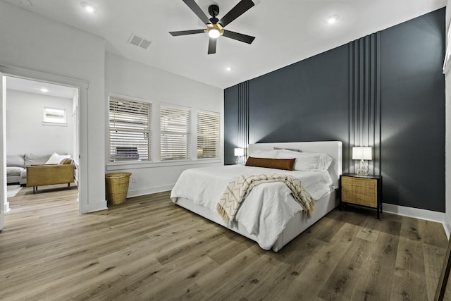 bedroom with hardwood / wood-style floors and ceiling fan